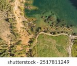 Aerial drone photo of Quarry turquiose lake colour, open pit mining in Park Grodek, Jaworzno. Poland. Turquiose Water and Wooden Bridge. Polish Maldives Park Grodek in Jaworzno from drone.