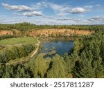 Aerial drone photo of Quarry turquiose lake colour, open pit mining in Park Grodek, Jaworzno. Poland. Turquiose Water and Wooden Bridge. Polish Maldives Park Grodek in Jaworzno from drone.