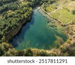 Aerial drone photo of Quarry turquiose lake colour, open pit mining in Park Grodek, Jaworzno. Poland. Turquiose Water and Wooden Bridge. Polish Maldives Park Grodek in Jaworzno from drone.