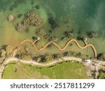 Aerial drone photo of Quarry turquiose lake colour, open pit mining in Park Grodek, Jaworzno. Poland. Turquiose Water and Wooden Bridge. Polish Maldives Park Grodek in Jaworzno from drone.