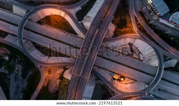 Aerial drone\
photo of ring road, multilevel circular junction road, road\
junction. Aerial view of the transportation, traffic, route road at\
night in the city of Chiangmai\
Thailand.