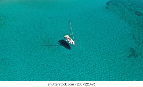 Aerial Drone Photo Of Sail Boat Anchored In Tropical Turquoise And Sapphire Sea