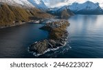 Aerial drone photo of the small island fishing town of Husøy on Senja, Norway.  A fishing village located in the Arctic Circle of Northern Norway.  Shot with a DJI Air 2s