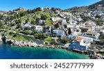 Aerial drone photo of small picturesque seaside village and harbour of Kaminia located near main village of Hydra island accessible by footpath, Saronic gulf, Greece