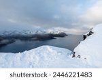 Aerial drone photo of snowy mountain hike near Segla in Senja, Norway.  Snowcapped mountains in the Arctic Circle of Northern Norway.  Famous hike on Senja island.