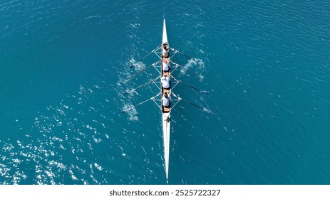 Aerial drone photo of sport canoe operated by team of young trained athletes in deep emerald sea - Powered by Shutterstock