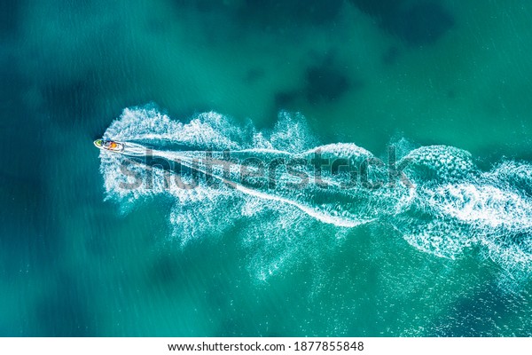 Aerial drone photo\
of stunt man performing extreme stunts with jet ski water craft\
over the Black sea at\
dusk