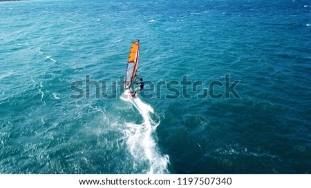 Aerial drone photo of surfer cruising in high speed in mediterranean open wavy  sea Foto d'archivio © 