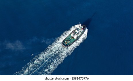 Aerial Drone Photo Of Tug Boat Cruising Mediterranean Port