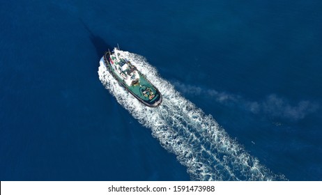 Aerial Drone Photo Of Tug Boat Cruising Mediterranean Port