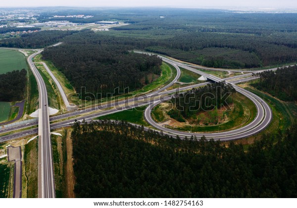 Aerial drone photography of the city suburbs,\
highway around the main city.\
