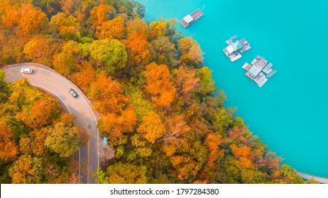 Aerial Drone Photography top view road going Road through autumn forest at Sun Moon Lake in Taiwan.