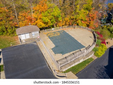 Aerial Drone Point Of View Of A Green Plastic Cover On HOA Swimming Pool Protecting It From Leaves And For The Winter Storms