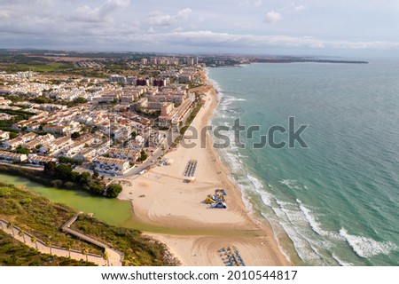 Aerial drone point of view sandy beach of Mil Palmeras, Mediterranean sea in the early morning. Costa Blanca, Spain. Summer holidays and travel concept