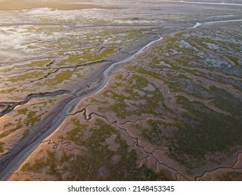 Aerial drone. Salt marshes at low tide exposing mud flats and streams at Motney Hill, Medway, Kent, England.