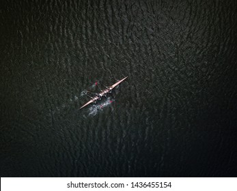 Aerial Drone Shot Af Academic Rowing Team In Canoe On Dark River