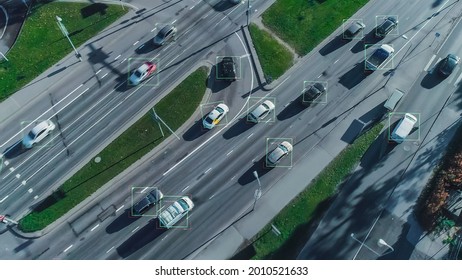 Aerial Drone Shot: Autonomous Self Driving Cars Moving On City Freeway. Concept: Artificial Intelligence Scans Cars and Pedestrians, Following Movement and Showing Data.