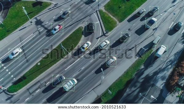 Aerial Drone Shot:\
Autonomous Self Driving Cars Moving On City Freeway. Concept:\
Artificial Intelligence Scans Cars and Pedestrians, Following\
Movement and Showing\
Data.