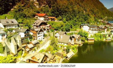 An aerial drone shot of a beautiful Hallstatt Hideaway hotel cottages on a sunny day in summer - Shutterstock ID 2158062569