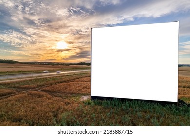 Aerial Drone Shot Of Big Blank Billboard Near Busy Highway Or Motorway At Sunset