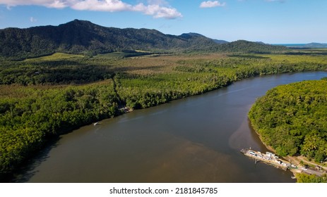 Aerial Drone Shot Of The Daintree River, Daintree Rainforest, And Daintree National Park In Tropical Far North Queensland Near Port Douglas And Cairns Featuring The Ferry Loaded With Cars.