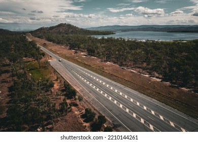 Aerial Drone Shot Of A Highway In The Tablelands Region Of Far North Queensland Featuring Mountains, Australian Bush And An Inland Lake