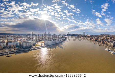 Aerial drone shot of Hungarian Parliament with overcast clouds in Budapest Winter morning