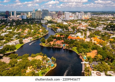 Aerial Drone Shot Of Luxury Neighborhood In Miami With Bay With Boats Sailing, Ocean And Blue Sky, Cityscape In The Background