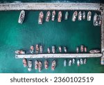 A aerial drone shot of many fishing boats in Kalk Bay harbour, near Cape Town, South Africa