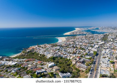 Aerial Drone Shot Over Corona Del Mar In Orange County, California With Coastal Neighborhood And Homes On A Sunny Blue Sky Day.