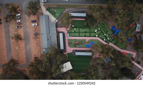 Aerial Drone Shot Over Mini Gold Course And Gravel Car Park
