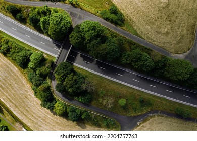 An Aerial Drone Shot Of A Pedestrian Bridge Over The Streets