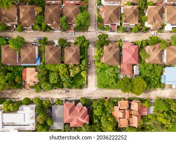 Aerial drone shot of suburb area surrounded by green eco-friendly environment for housing estate project from top view angle - Shutterstock ID 2036222252