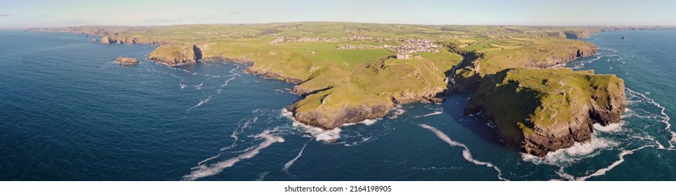 Aerial Drone Shot Of Tintagel, Rugged And Rocky Stretch Of Coastline With Cliffs And Rough Seas, Cornwall, South West England