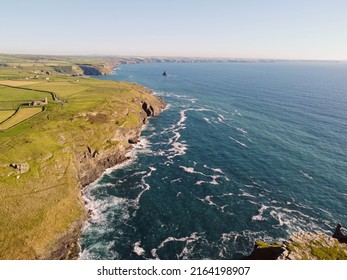 Aerial Drone Shot Of Tintagel, Rugged And Rocky Stretch Of Coastline With Cliffs And Rough Seas, Cornwall, South West England