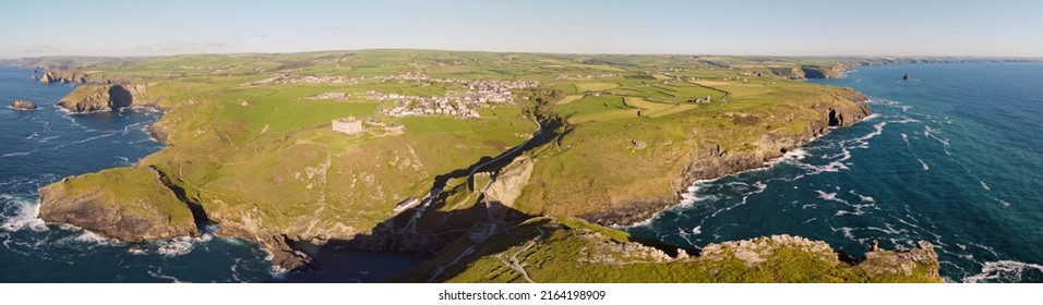 Aerial Drone Shot Of Tintagel, Rugged And Rocky Stretch Of Coastline With Cliffs And Rough Seas, Cornwall, South West England