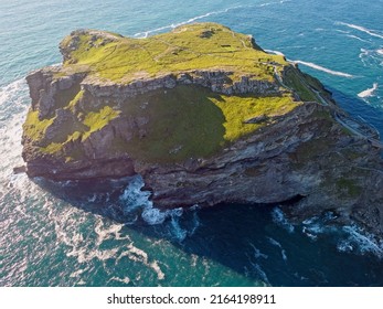 Aerial Drone Shot Of Tintagel, Rugged And Rocky Stretch Of Coastline With Cliffs And Rough Seas, Cornwall, South West England