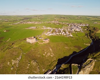 Aerial Drone Shot Of Tintagel, Rugged And Rocky Stretch Of Coastline With Cliffs And Rough Seas, Cornwall, South West England