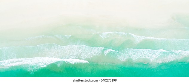Aerial drone shot of turquoise sea water at the beach - panoramic banner