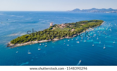 Aerial drone shot view of yachts between Ile Sainte Marguerite and Ile Saint Honorat in mediterranean sea