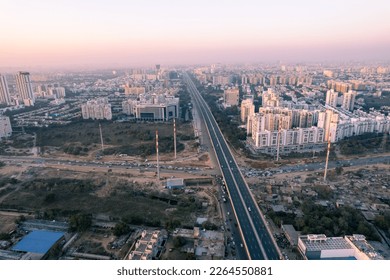 aerial drone still shot showing busy sohna elevated highway toll road with traffic stuck at interesction due to road construction of bridge or underpass - Powered by Shutterstock