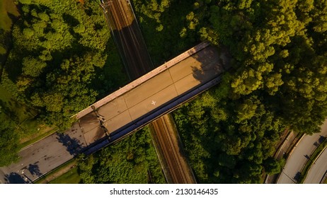 Aerial Drone top down Footage Of  bridge pass over railway track during sunrise