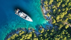 Aerial Drone Top Down Photo Of Inflatable Speed Boat Anchored In Tropical Exotic Island Covered With Pine Trees