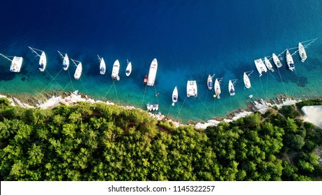 Aerial drone top down photo of sail boats and yachts anchored in traditional fishing village of Fiskardo, Kefalonia island, Ionian, Greece - Powered by Shutterstock