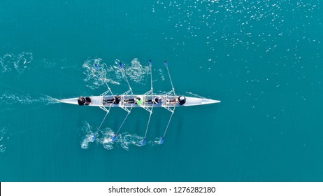 Aerial drone top down photo of sport canoe operated by team of young women in emerald calm sea waters - Powered by Shutterstock