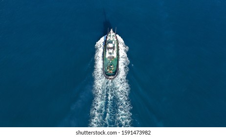 Aerial Drone Top Down Photo Of Tug Boat Cruising Mediterranean Port