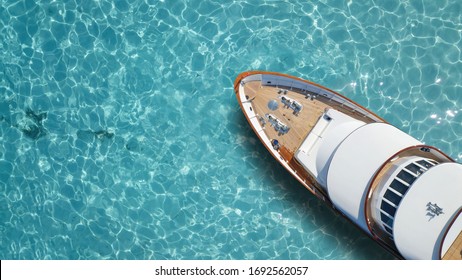 Aerial drone top down photo of luxury yacht nose with wooden deck anchored in paradise exotic turquoise island bay - Shutterstock ID 1692562057