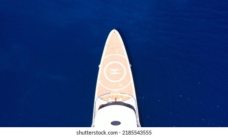 Aerial Drone Top Down Photo Of Luxury Mega Yacht With Wooden Deck And Helipad Anchored In Deep Blue Mediterranean Sea