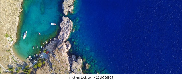 Aerial Drone Top Down Ultra Wide Photo Of Paradise Bay Of Saint Paul Next To Iconic Castle And Village Of Lindos, Rodos Island, Dodecanese, Greece