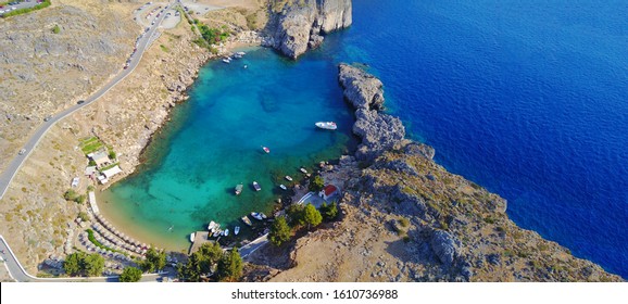 Aerial Drone Top Down Ultra Wide Photo Of Paradise Bay Of Saint Paul Next To Iconic Castle And Village Of Lindos, Rodos Island, Dodecanese, Greece